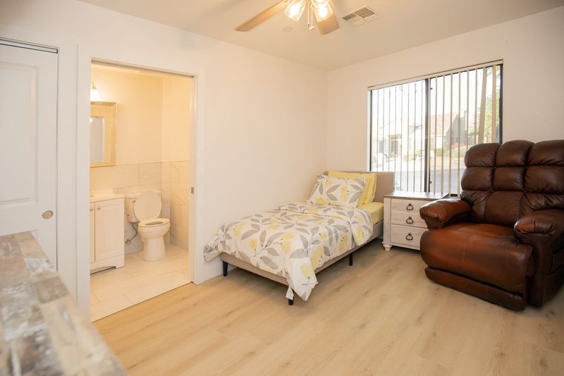 Resident bedroom with a chaise lounge and leather recliner