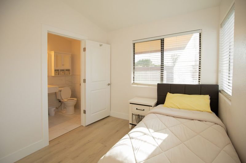 Resident bedroom with a view into its own bathroom