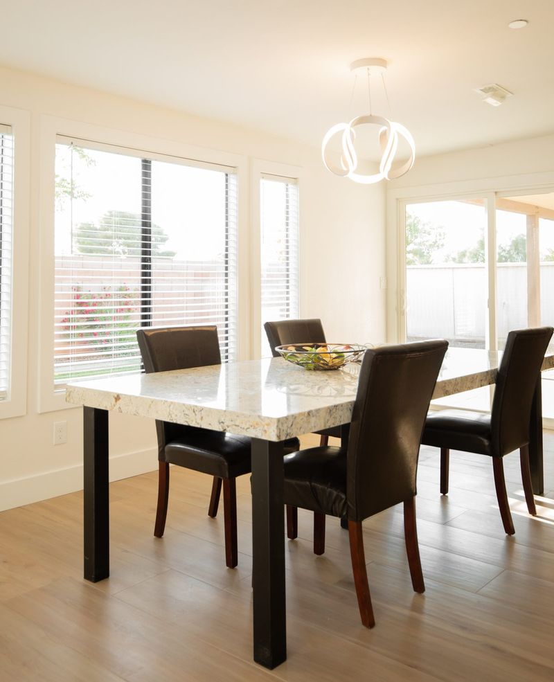 Dining area with a chandelier and large windows