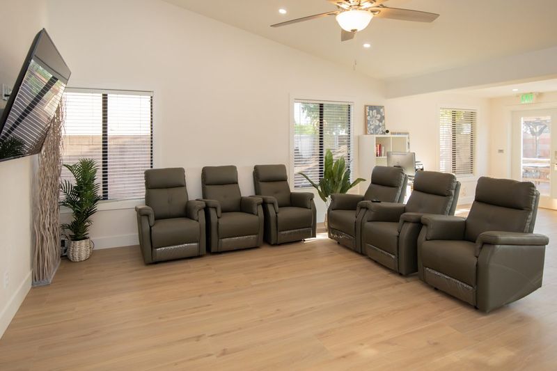 Family room with a row of power recliners facing the television