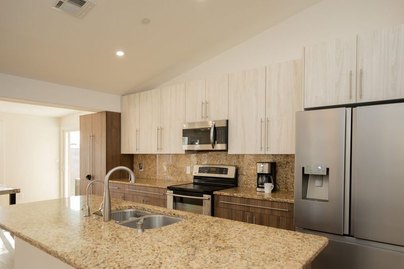 Kitchen with a granite island and stainless steel appliances